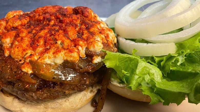Open burger with bleu cheese, onions, lettuce, and sauce