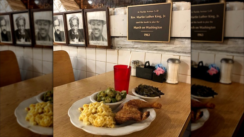 Chicken, okra, and mac & cheese platter on wooden table at Florida Avenue Grill