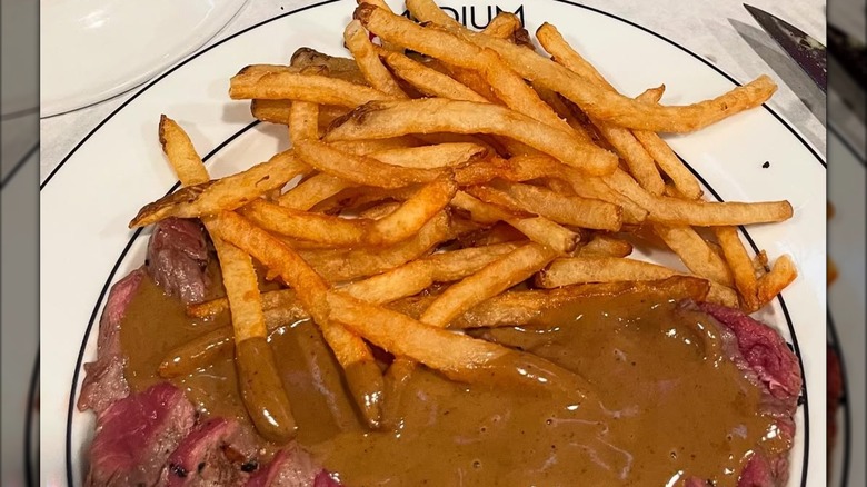 Plate of medium rare steak frites