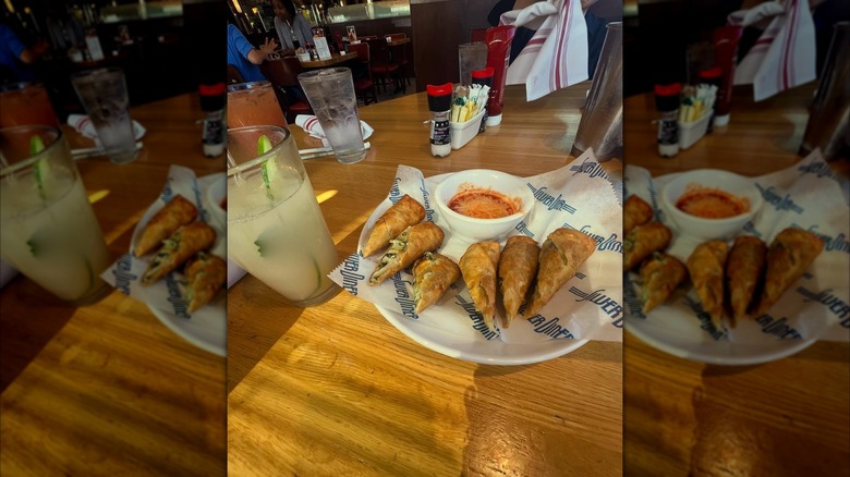 Eggroll appetizer and mojito on wooden table at the Silver Diner