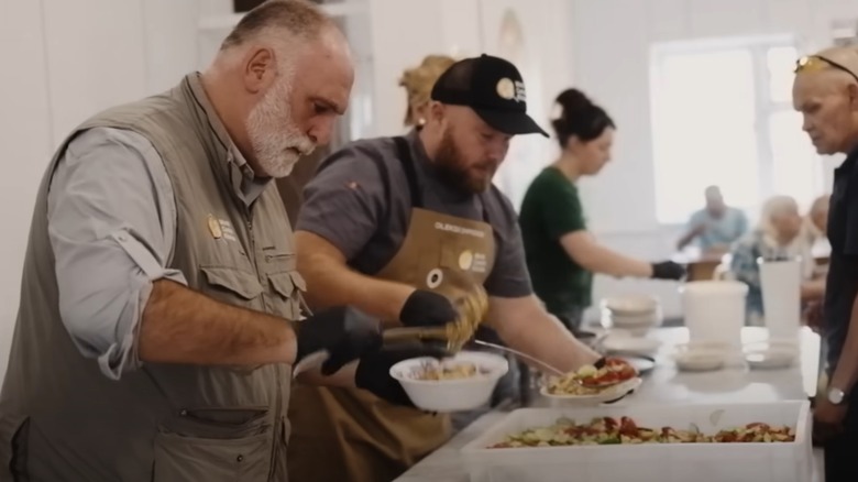 Jose Andres plating food at a buffet line