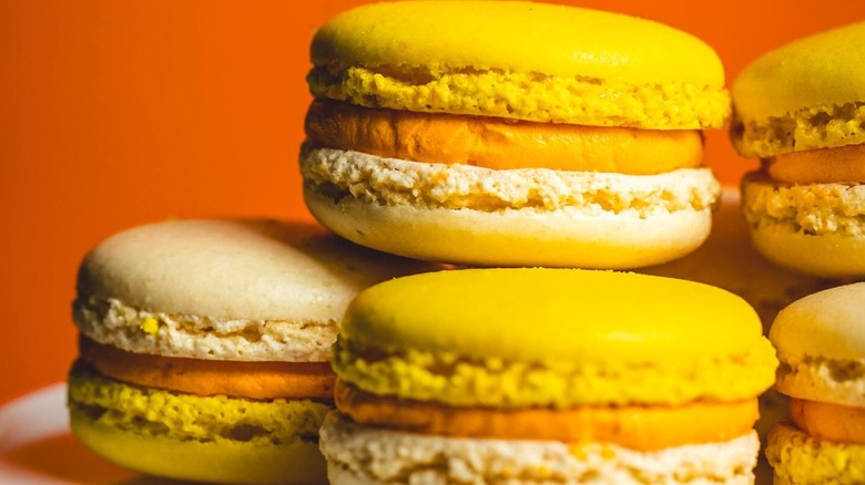 Candy corn macarons on orange background