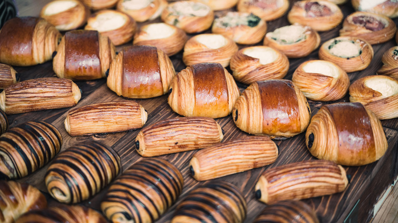 Assortment of croissants and pastries on wooden table