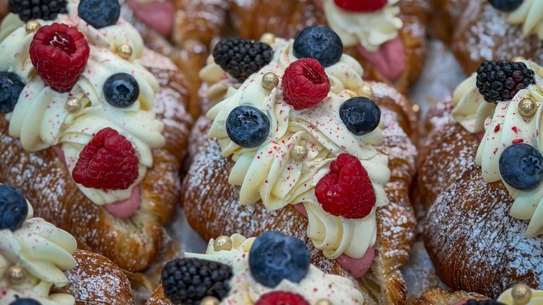 Croissants with raspberries, blueberries, blackberries, and icing