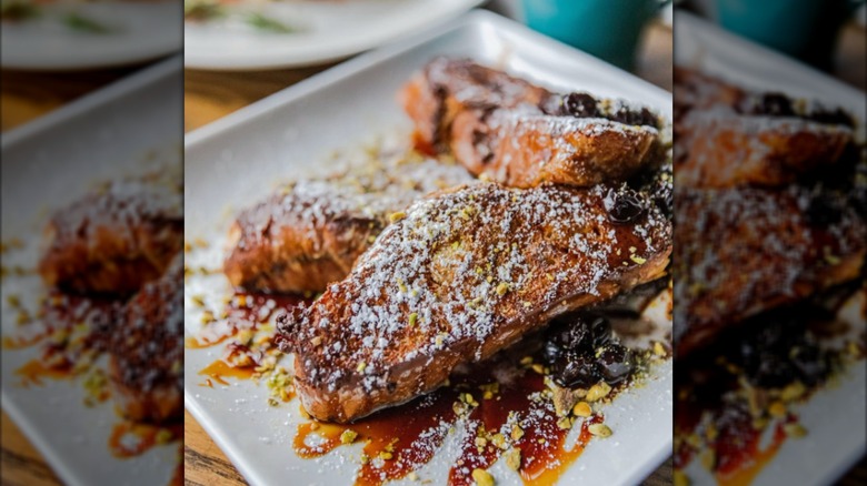 French toast made with tsoureki and fig syrup on a white plate