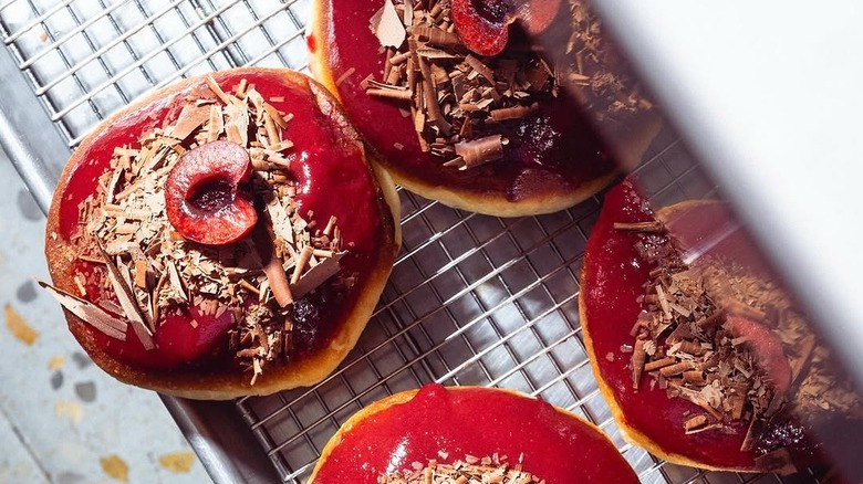 Top view of cherry and chocolate glazed donuts from Hani's Bakery