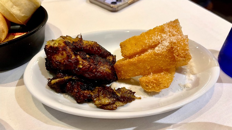 Caramelized bananas and fried polenta on white plate at Fogo de Chão