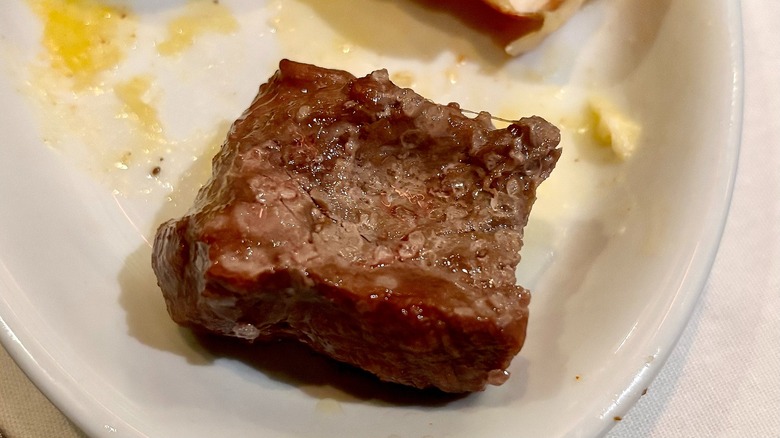 Filet mignon on white plate at Fogo de Chão
