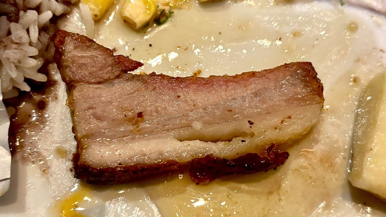 Pork belly on white plate at Fogo de Chão
