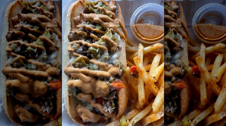 Philly cheesesteak with fries and sauce