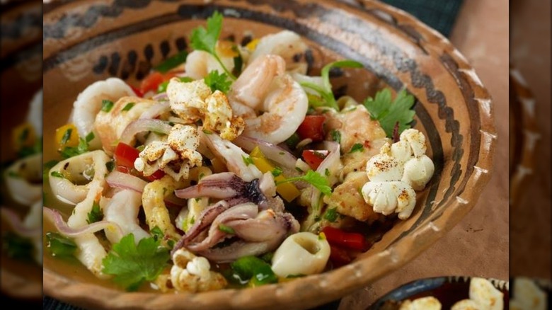 Ceviche in a brown pottery dish