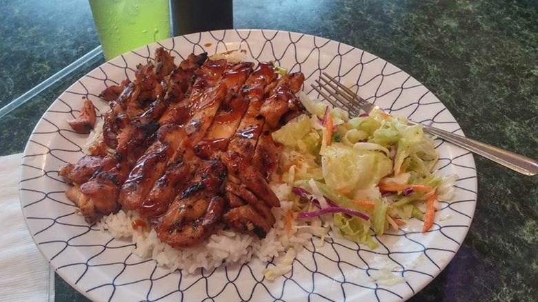 Chicken teriyaki on top of rice with salad