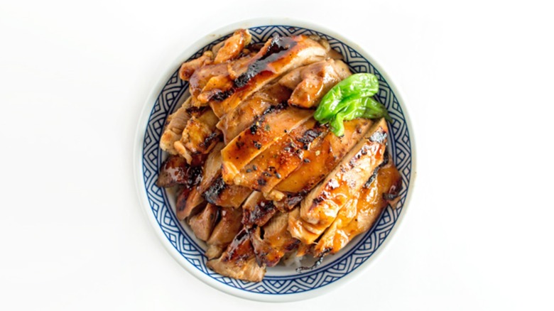 Bowl of chicken teriyaki on white background