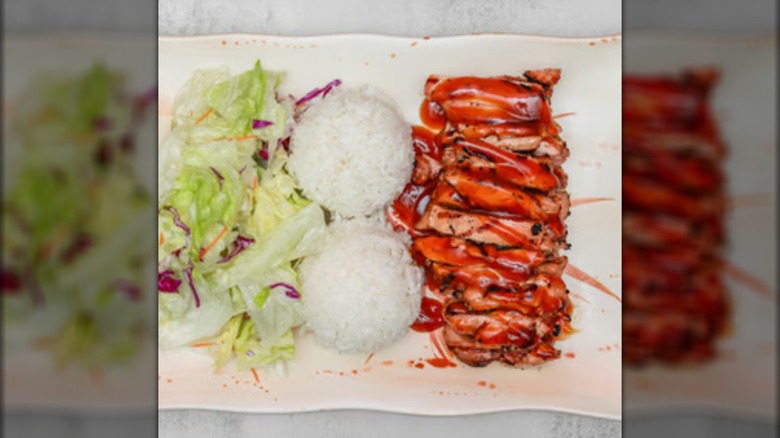Plate of teriyaki, two scoops of rice, and salad