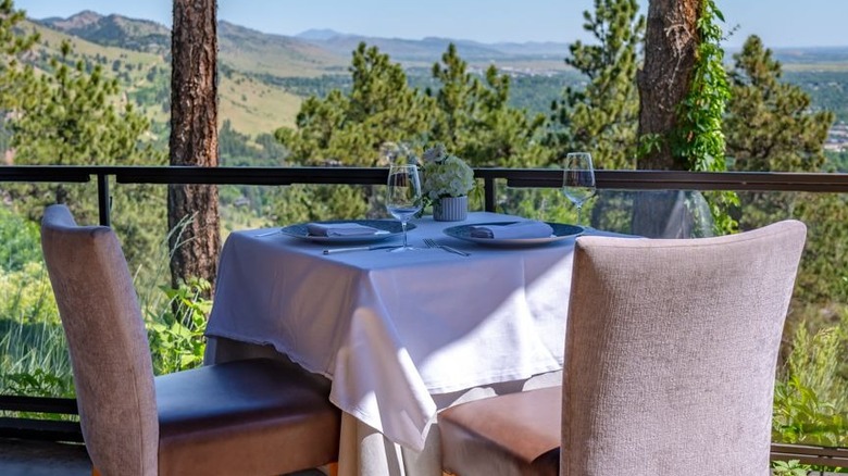 Table for two outdoors with mountain view at Flagstaff House Restaurant