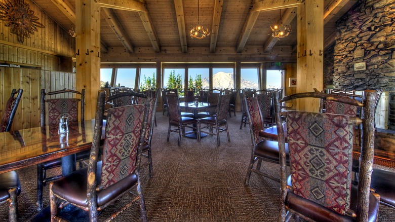 Summit House Restaurant's cozy interior with large windows and views of snowy mountains