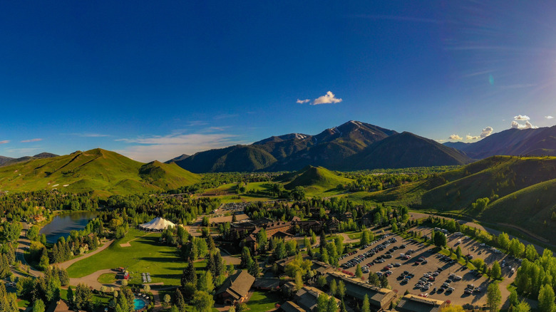 Sun Valley Resort surrounded by lush greenery and mountains under a blue sky