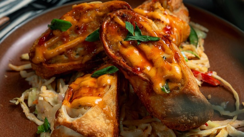 Crab egg rolls cut in half on plate