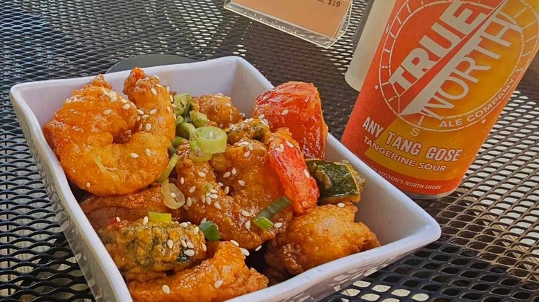 Firecracker shrimp dish with peppers and can of gose beer