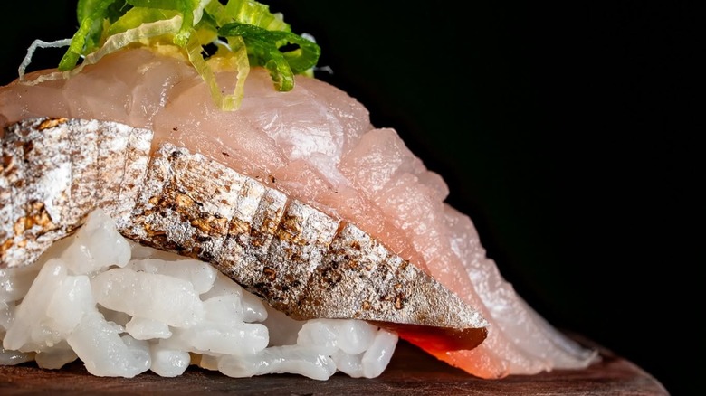 Close-up of sushi with rice and greens