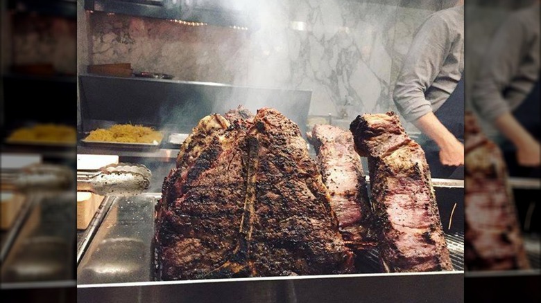 Finished steaks in a silver tray in the kitchen