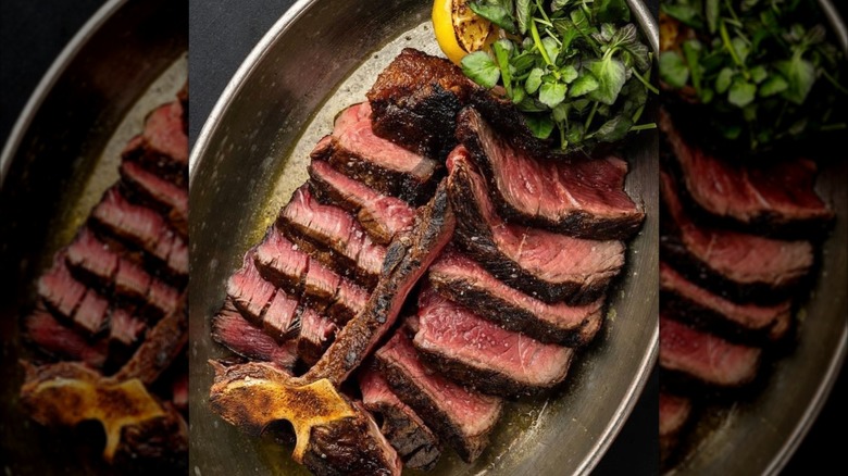 Steak sliced off the bone with greens