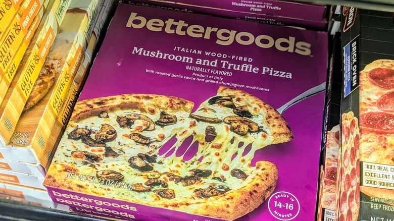 A purple box of bettergoods brand pizza in a freezer at Walmart