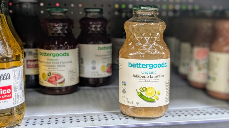 A glass jar of jalapeno limeade on a juice shelf at Walmart