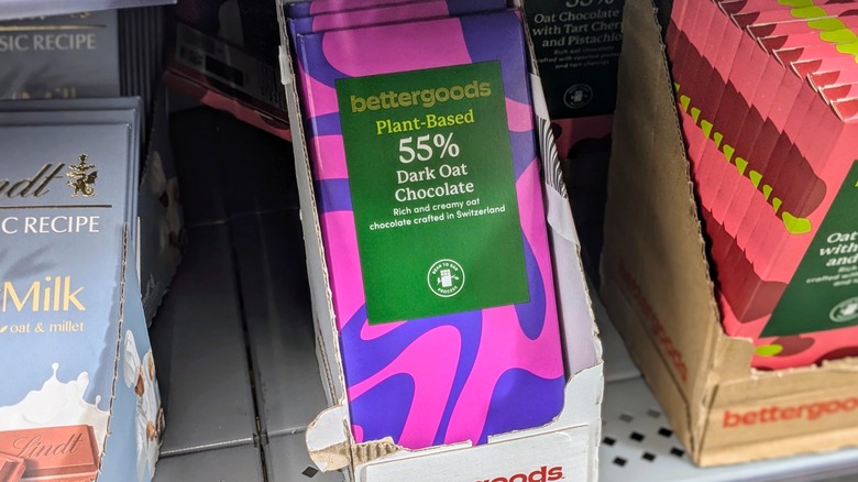 Purple oat chocolate bars in a cardboard display on a shelf at Walmart