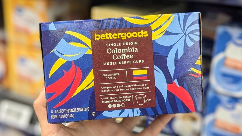 A hand holds a box of Colombian coffee K-Cups at Walmart