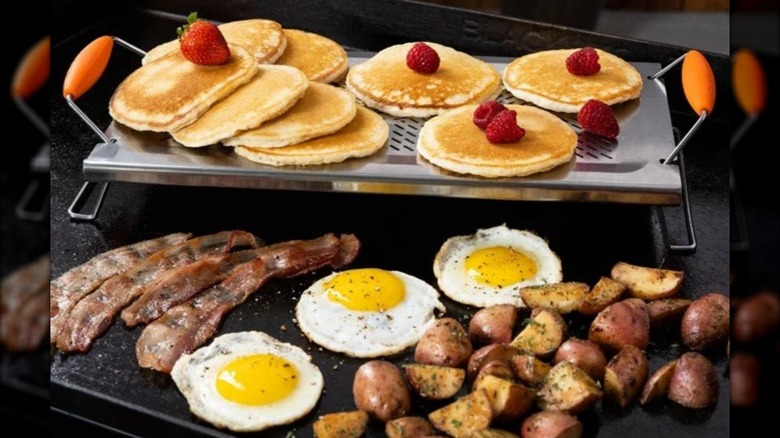 Blackstone Adjustable Warming Rack holding flapjacks with raspberries