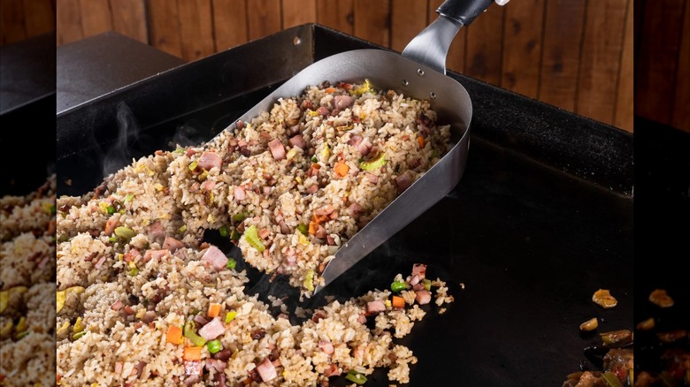Blackstone Griddle Scoop being used on a Blackstone Griddle to shovel fried rice