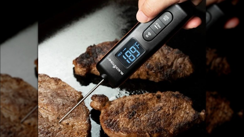 Blackstone Infrared Thermometer with Probe checking the temp of meat