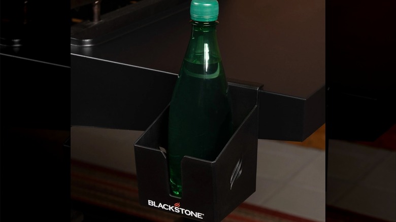 Blackstone Magnetic Tool and Beverage Holder on a Blackstone Griddle with a green bottle of soda