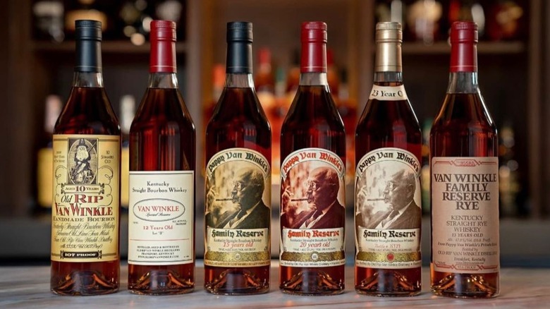 The full line up of Old Rip Van Winkle bottles placed in front of a blurred home bar background