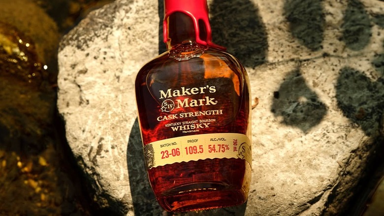 A top-down shot of a bottle of Maker's Mark Cask Strength perched on a rock