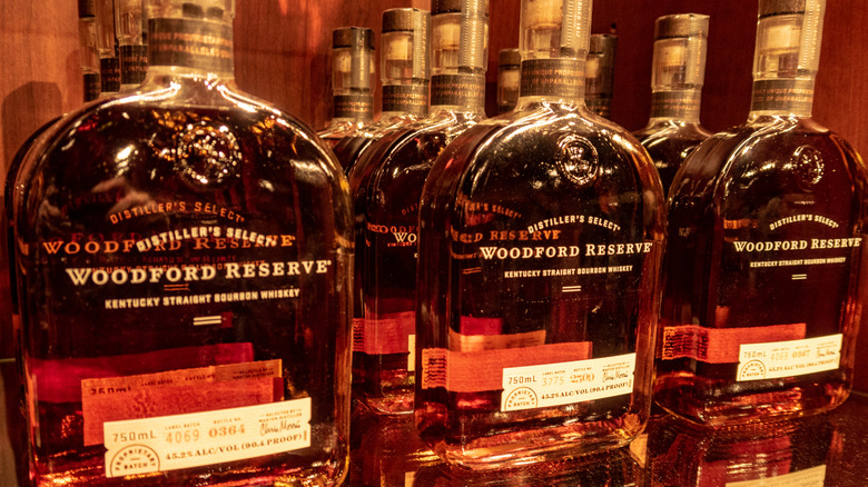 Three rows of Woodford Reserve stacked on a liquor shelf