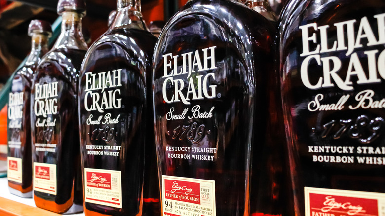 A row of Elijah Craig Small Batch bottles on a liquor shelf