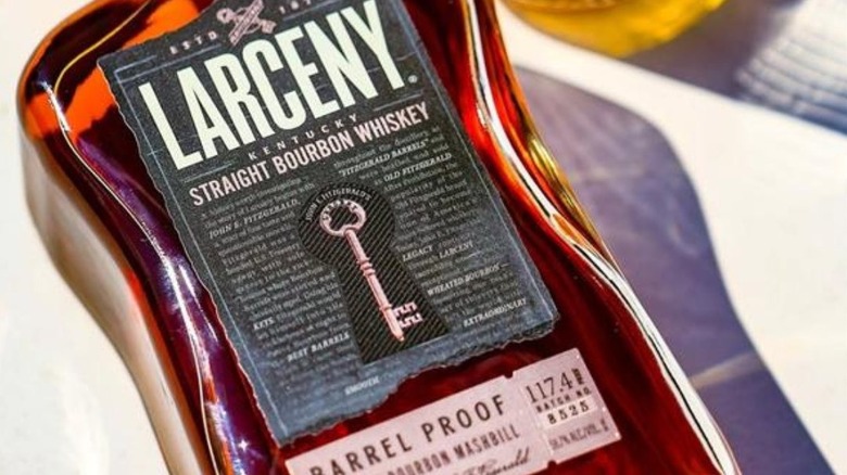 A close-up of a bottle of Larceny Barrel Proof resting on a blurred surface