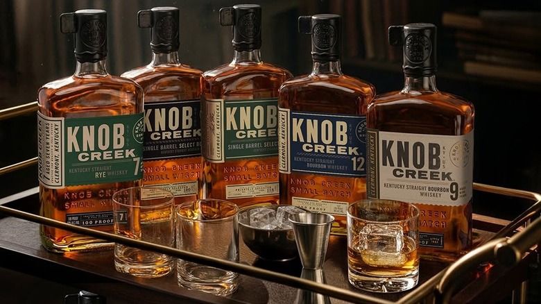 A range of Knob Creek expressions on top of a drinks cart with glasses and ice