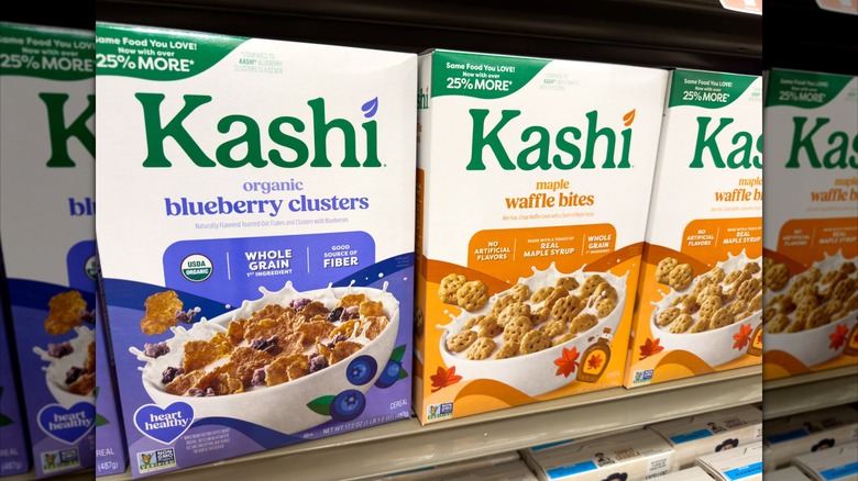 Two different boxes of Kashi cereal, displayed on a store shelf.