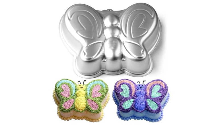 A butterfly cake pan mold with decorated cakes below it