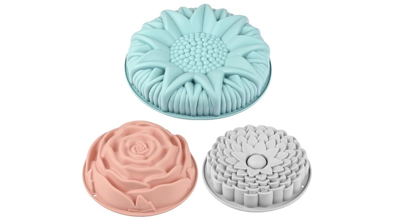 three colorful silicone molds of flowers for cakes