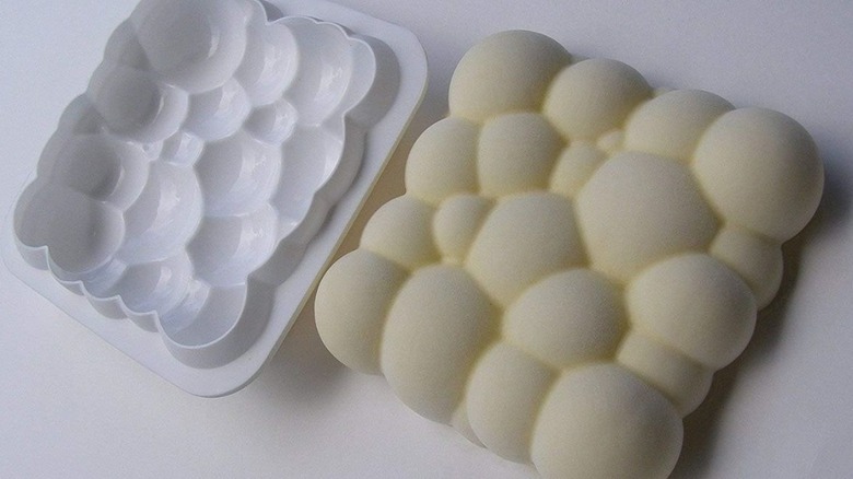 closeup of a cloud shaped cake cold and a cake next to it