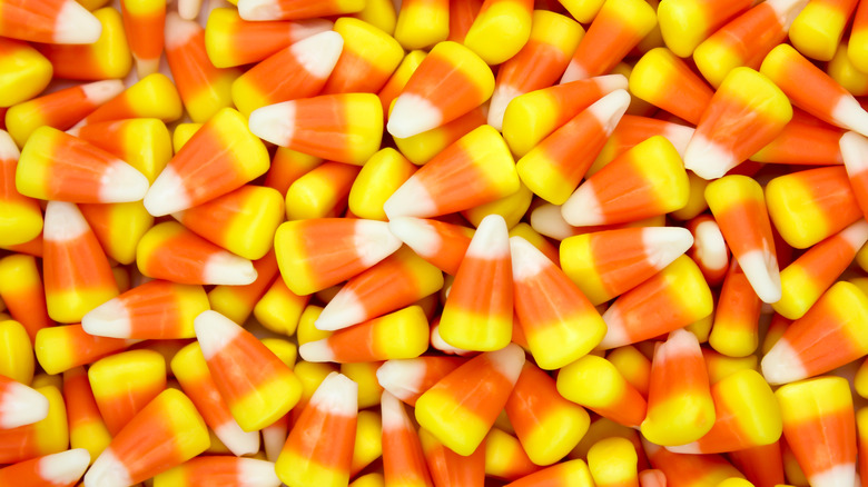 A pile of candy corn on a white background