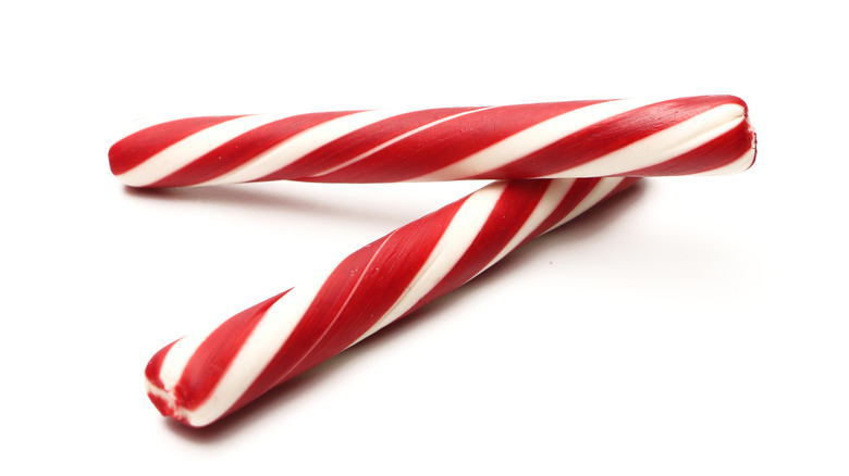 Two peppermint sticks on white background