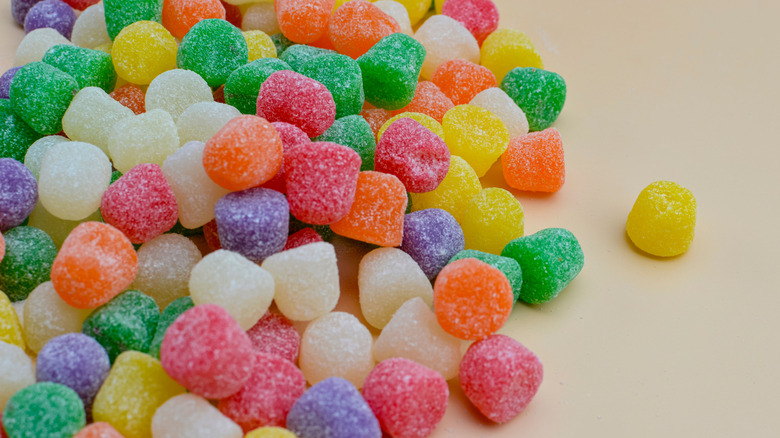Group of gumdrops lie on an off-white background
