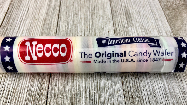 Tube of Necco wafers sitting on a wooden table