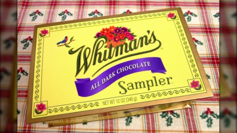 Box of Whitman's all dark chocolates on a checkered holly tablecloth