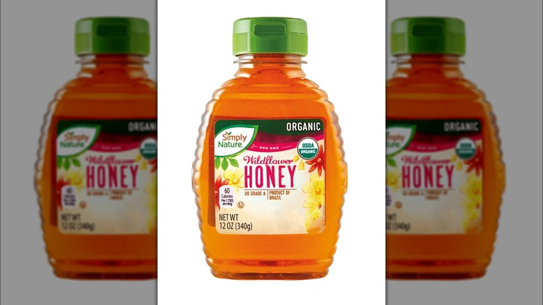 A Simply Nature wildflower honey container on a white background